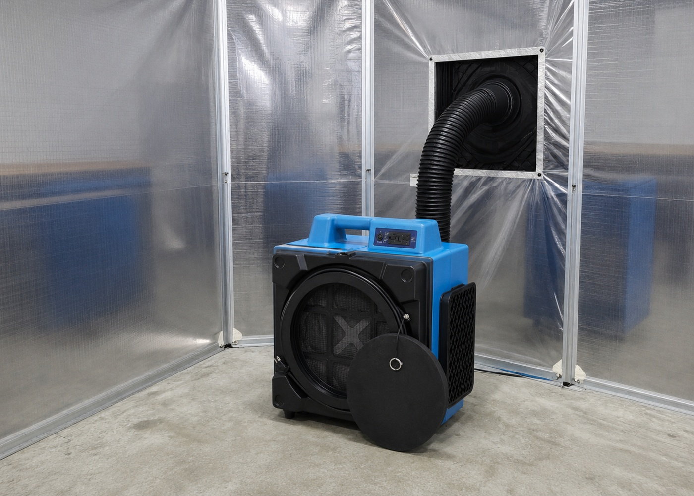 Negative air machine connected to ducting inside a sealed containment area